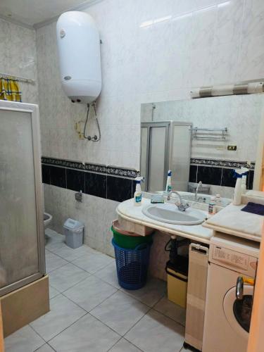 a bathroom with a sink and a large mirror at casabianca north coast chalet code 20 in Borg El Arab