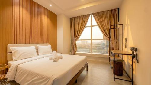 a bedroom with a bed with a teddy bear on it at Suasana JB Central by TPL in Johor Bahru