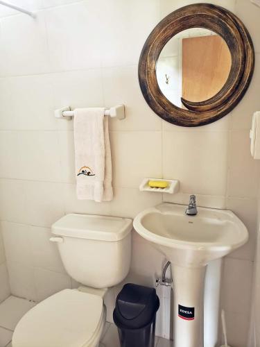 a bathroom with a toilet and a sink and a mirror at Finca Masada in Mira