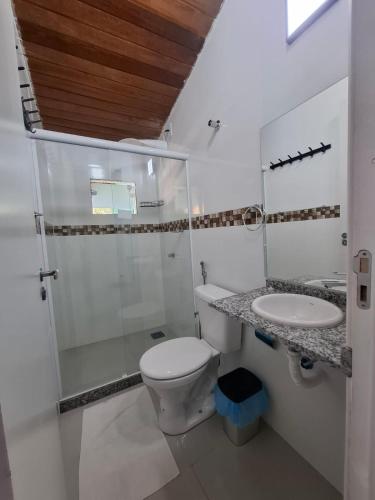 a bathroom with a toilet and a sink at Pousada Colibris da Barra da Tijuca in Rio de Janeiro