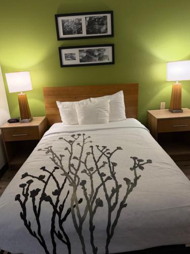 a bedroom with a bed with a tree print on it at Sleep Inn Hardeeville - I-95 in Hardeeville