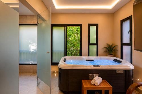 a large bathroom with a large soaking tub at Luxury Apartment with Private Jacuzzi & Pool Central Marrakech in Marrakesh