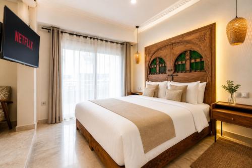 a hotel room with a large bed and a window at Luxury Apartment with Private Jacuzzi & Pool Central Marrakech in Marrakesh