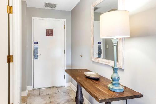 a room with a table with a lamp and a mirror at Resort Studio with Nature Preserve Views in Destin