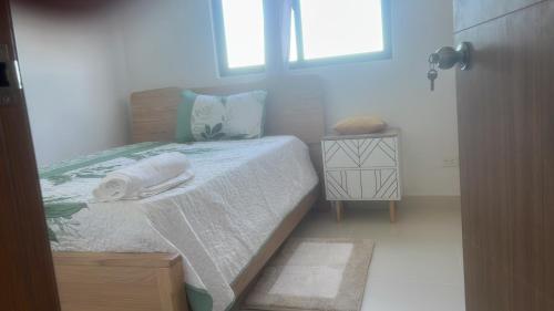 a small bedroom with a bed and a window at Dominican paradise in Punta Cana