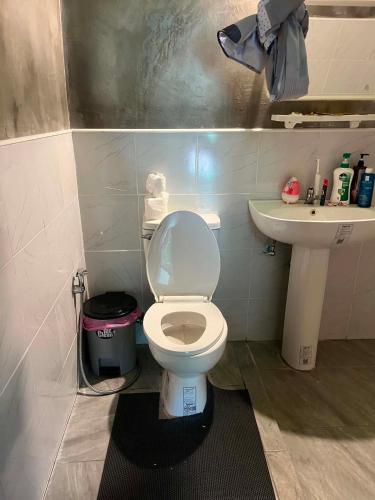 a bathroom with a white toilet and a sink at Hidden Gem Elephant in Chiang Mai