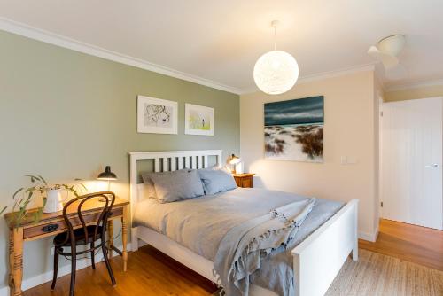 a bedroom with a bed and a desk at Stablebase in Albany