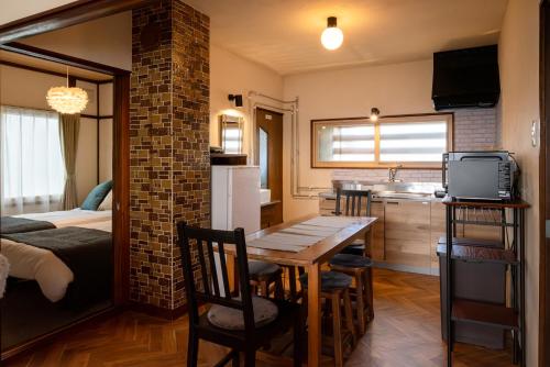 a kitchen and dining room with a table in a room at good day biei in Biei
