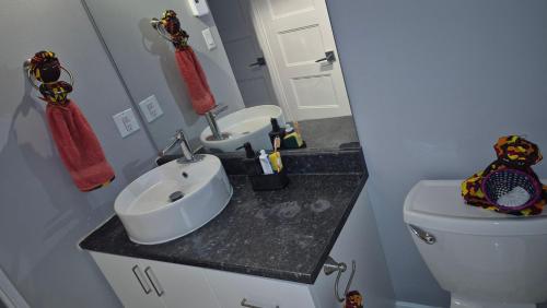 a bathroom with a white toilet and a sink at Messila in Gatineau