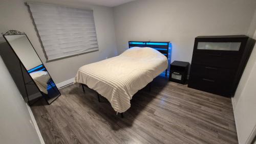a bedroom with a bed and a dresser and a mirror at Messila in Gatineau