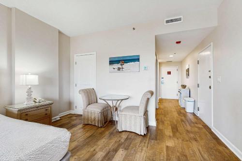 a bedroom with a bed and a table and chairs at TOPS'L Summit VI in Destin