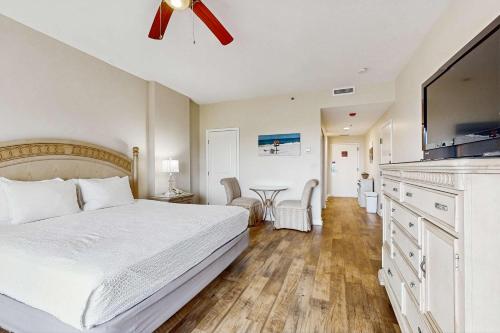 a bedroom with a bed and a flat screen tv at TOPS'L Summit VI in Destin
