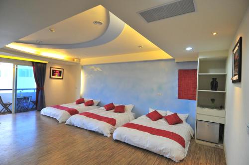 En eller flere senger på et rom på Penghu Camome
