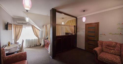 a living room with a door and a chair at Golden Palace in Dubove