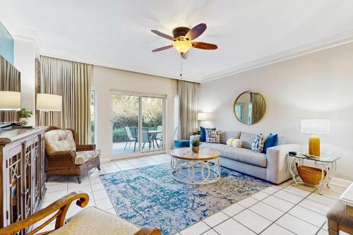 a living room with a couch and a ceiling fan at TOPS'L Summit 107b in Destin
