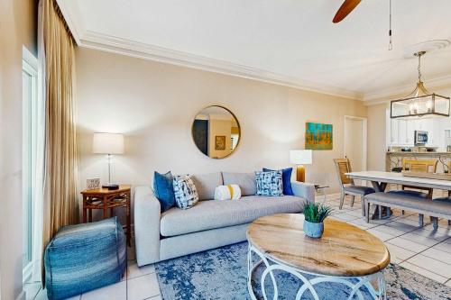 a living room with a couch and a table at TOPS'L Summit 107b in Destin