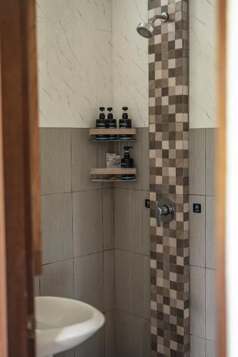a bathroom with a shower and a sink at Gunung Agung Timur in Amed