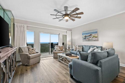a living room with a couch and a tv at TOPS'L Summit 809 2 Bedroom in Destin