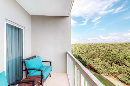 a blue chair sitting on a balcony with a view at TOPS'L Summit II in Destin