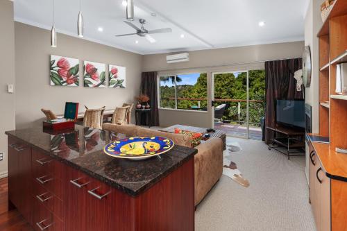 a living room with a couch and a table at Sanctuary Palms in Paihia