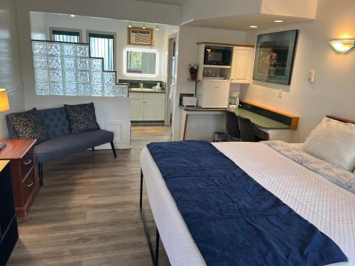 a bedroom with a bed and a living room at Motel Bavaria in Radium Hot Springs