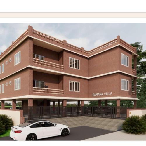 a rendering of a building with a car parked in front at Five Falls RAMANA VILLA in Kuttālam