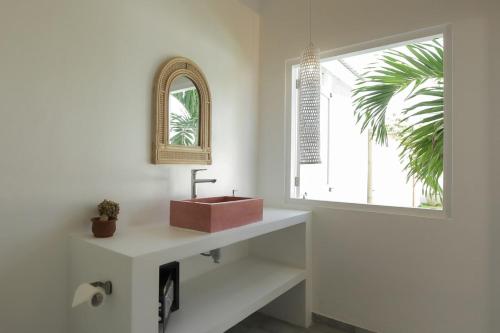 a bathroom with a sink and a window at Uluwatu - Beach Villa 5 in Uluwatu