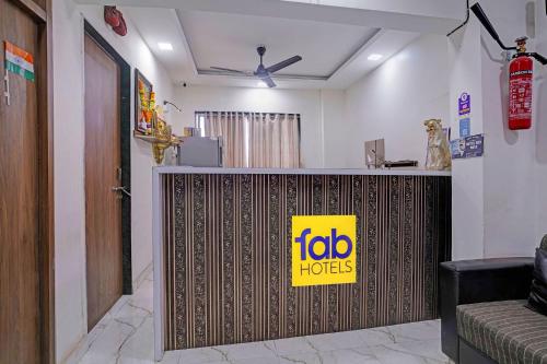 a restaurant with a sign on a reception counter at FabHotel Red Rose Palghar in Nale Sopāra