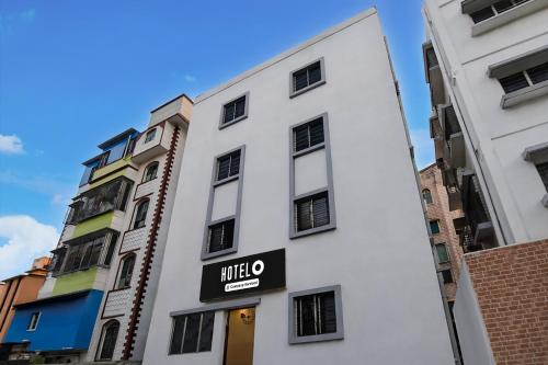 a white building with a sign for a hotel at Super Hotel O Acropolis Mall Kolkata Formerly The Orchid Residency in Kolkata