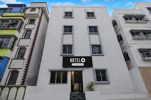 a white building with a hotel sign on it at Super Hotel O Acropolis Mall Kolkata Formerly The Orchid Residency in Kolkata