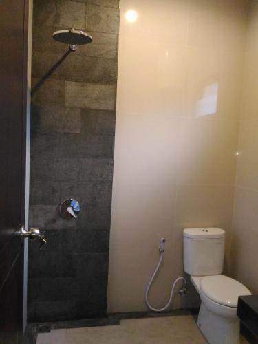 a bathroom with a toilet and a shower at Villa Reisya in Nusa Dua