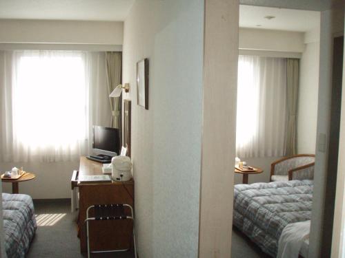 Postel nebo postele na pokoji v ubytování New Royal Hotel Shimanto