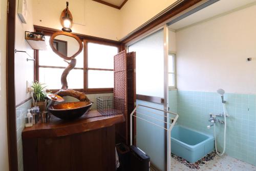 a bathroom with a sink and a bath tub at Casa di acero in Kikuchi
