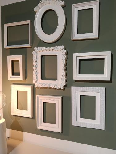 a wall with picture frames on a wall at Liberty 21 in Andria
