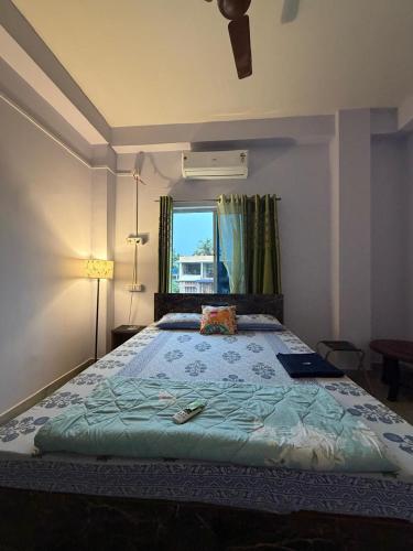 a bedroom with a large bed with a window at Windchime 9 in Guwahati