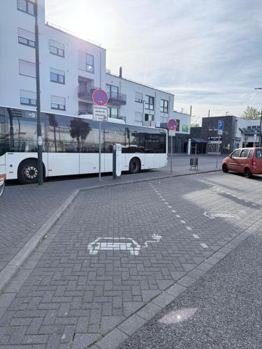 a bus parked in a parking lot next to a building at Home2Cologne in Kerpen