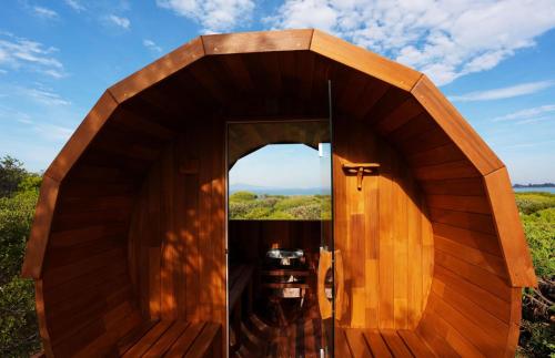 an open door of a wooden house with a window at Southerlys Beach House in Dolphin Sands