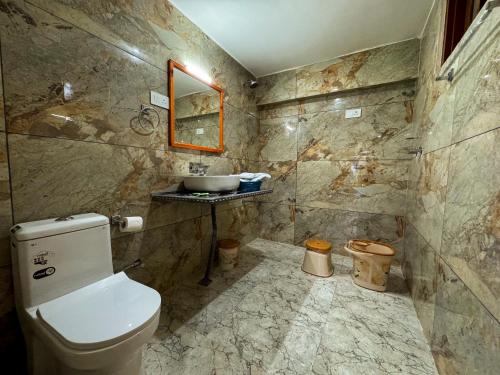 a bathroom with a toilet and a sink at The Other House Srinagar in Srinagar