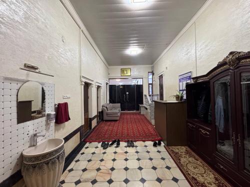 a hallway with a bathroom with a sink and a mirror at Dada guest house in Bukhara