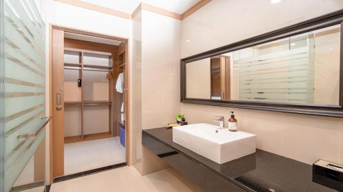 a bathroom with a white sink and a mirror at Lacol Khao Yai - A Chatrium Collection in Mu Si