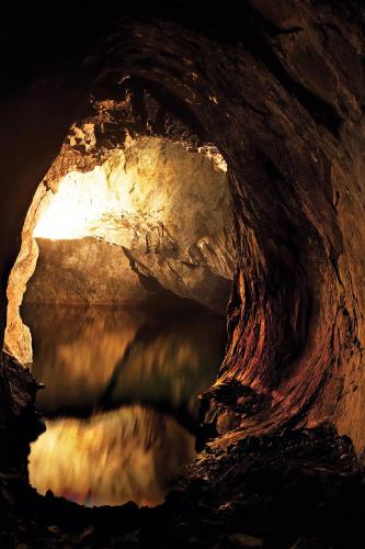 a cave with a body of water in it at Hotell Tinget in Sala