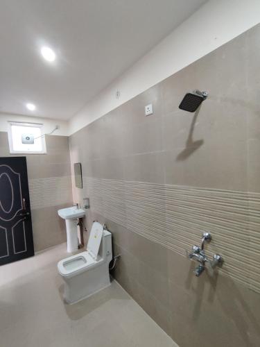 a bathroom with a toilet and a sink at Heaven Heights in Rājpur