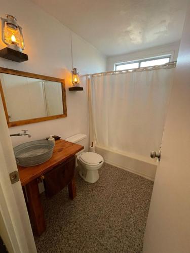 a bathroom with a toilet and a sink and a mirror at Casa Isabel in Ensenada