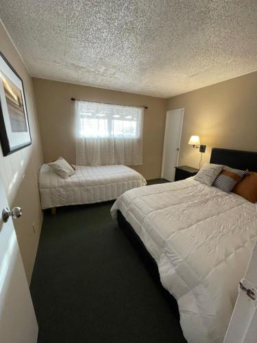 a hotel room with two beds and a window at Casa Isabel in Ensenada