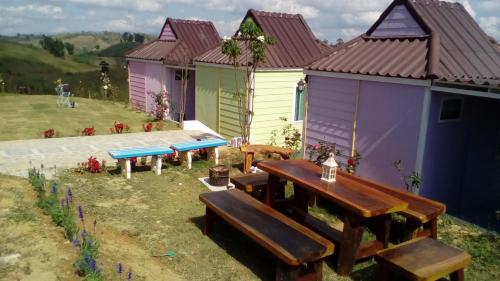 una casa con tavolo da picnic e panchine di Lovely Farm a Khao Kho
