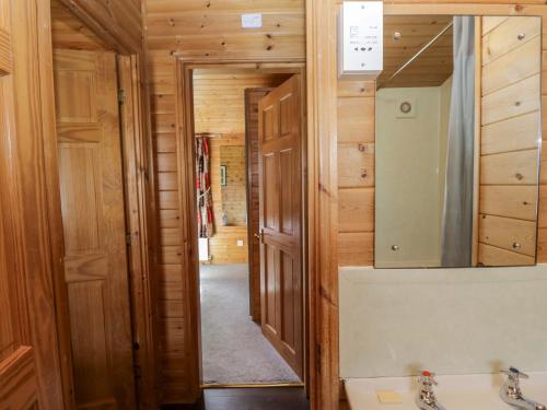 a bathroom with a sink and a mirror at Elm Lodge in Keswick