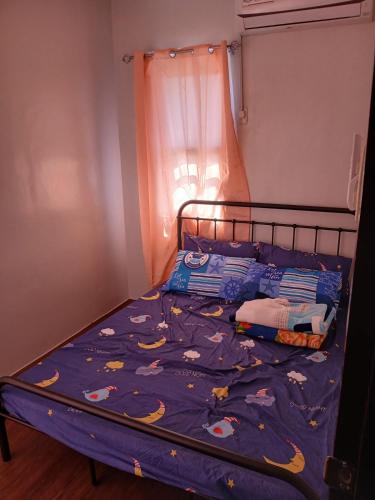 a bedroom with a bed with a blue comforter at A Peaceful House in Mexico