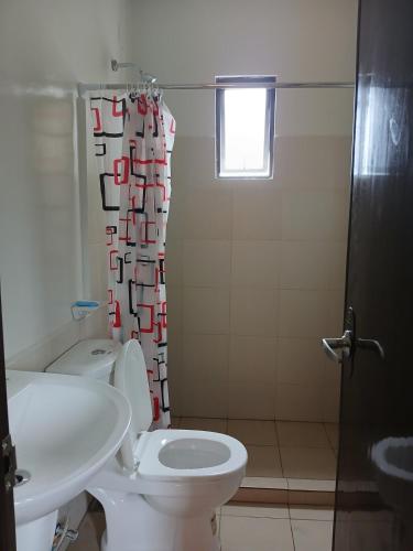 a bathroom with a toilet and a sink and a shower at A Peaceful House in Mexico