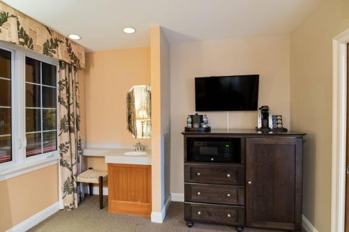 a room with a tv on top of a dresser at The Port Inn - Port St Joe, an Ascend Collection Hotel in Port Saint Joe