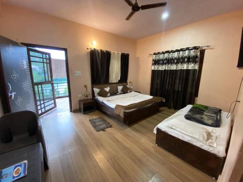 a bedroom with two beds and a window at The Mount lakes in Bhīm Tāl
